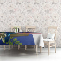 Blue and white tablecloth with bird and leaf graphic, red stripe on dining table