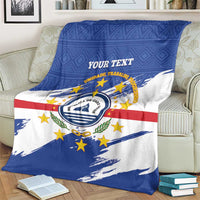 Cape Verde flag blanket draped with blue and white panels, red stripe, round emblem