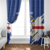 Blue Cape Verde coat of arms curtain panels framing a window with red stripe and star details.