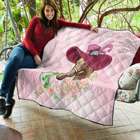 Pink quilt draped on couch, horse head graphic with mint-julep hat and roses