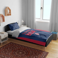 Blue and red USA bedding set with “YOUR TEXT” and shield graphic on bed