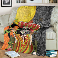 Dia de los Muertos blanket on couch with sugar skull, sombrero, and bold Aztec pattern