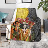 Dia de los Muertos blanket showing gold and black panels with sugar skull and sombrero