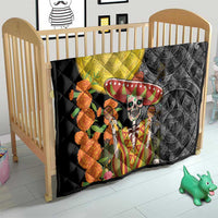 Quilt spread on a light-wood crib, black-and-gray with yellow circle and sugar skull sombrero