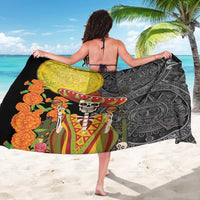 Black sarong held open with yellow crest and sugar skull scene, floral accents