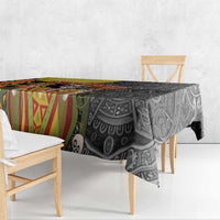 Black tablecloth draped over table with multicolor Aztec-style patterns and skull motif