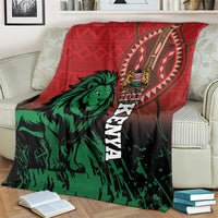 Red and green Kenya lion blanket spread on a couch, vertical “KENYA” text visible