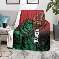 Red and green Kenya lion blanket with crest emblem and vertical “KENYA” text on gray sofa