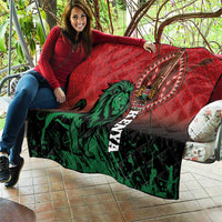 Red quilt blanket spread on patio couch, with green lion and vertical Kenya text