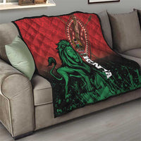 Red and black quilt draped over sofa with green lion, Kenya emblem, and Kenya lettering
