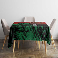 Kenya independence day tablecloth centered on dining table, green pattern with red top band.