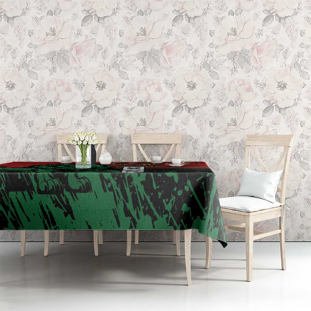 Kenya independence day tablecloth on long dining table, green patterned section and red trim.