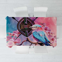 Pink floral tablecloth with orchid blooms and a coat of arms crest design