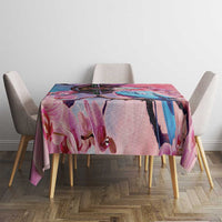 Pink orchid tablecloth covering a table with four light gray upholstered chairs