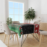 Rectangular Christmas tablecloth in red, black, green with lion Santa graphic.