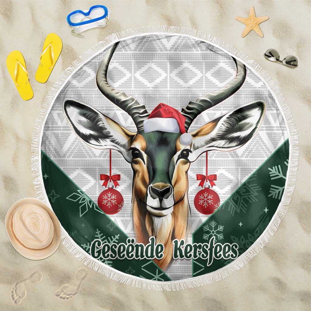 Round fringed beach blanket with green and white Bokke deer Santa design