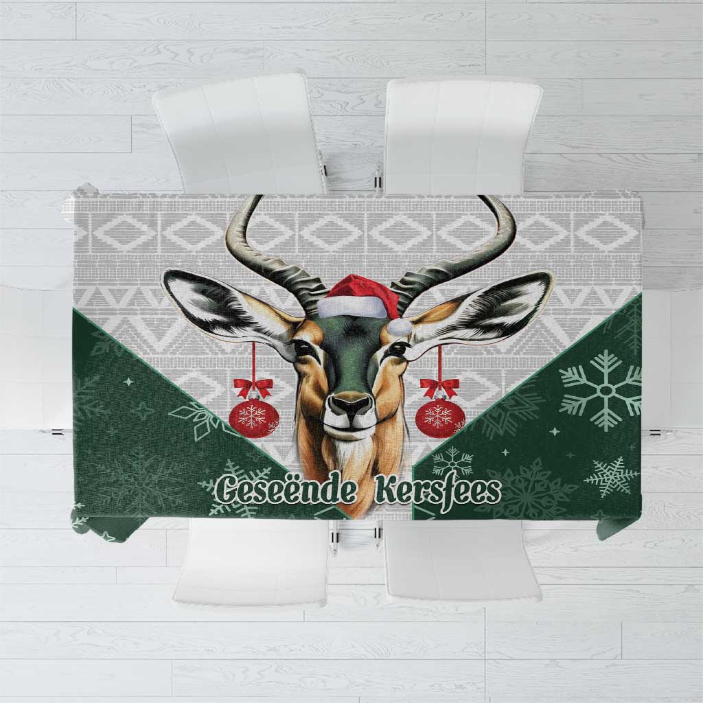 Green Christmas tablecloth with deer Santa graphic and “Geseende Kersfees” text