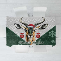 Green Christmas tablecloth with deer Santa graphic and “Geseende Kersfees” text