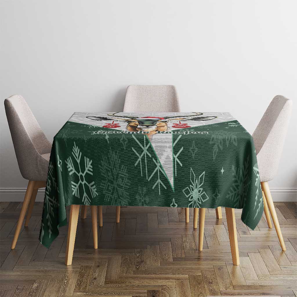 Green Christmas tablecloth with snowflake pattern and central deer graphic