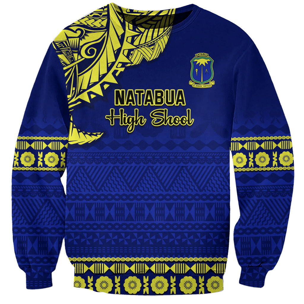 Blue sweatshirt with neon yellow Fijian tapa pattern and Natabua High School crest front