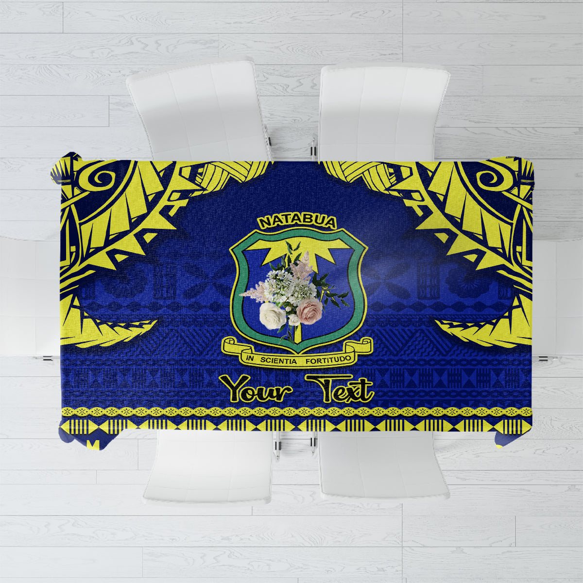 Blue tablecloth with green yellow tapa pattern, decorative border and crest medallion.