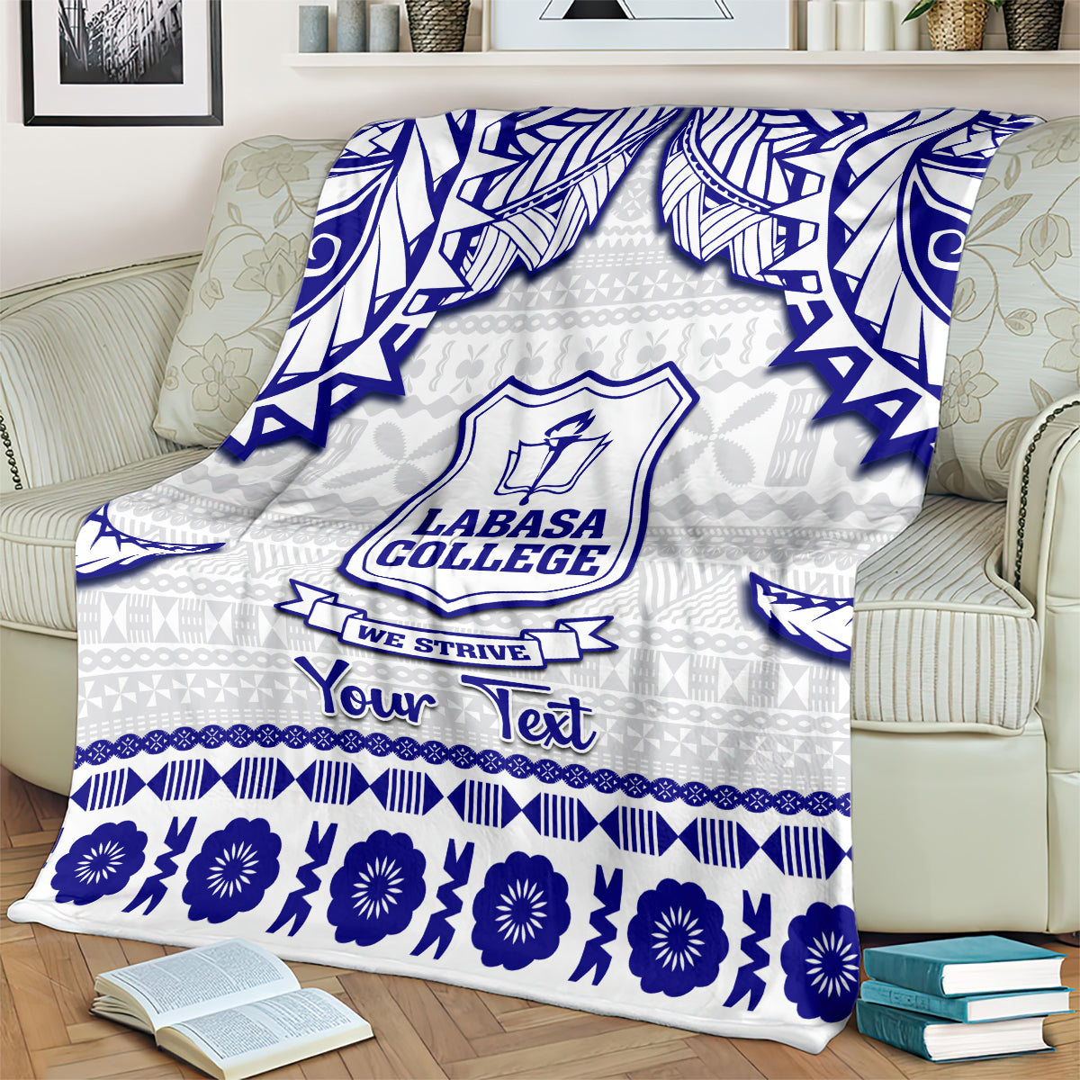 Personalized college blanket draped on sofa; light gray and blue with Labasa College crest