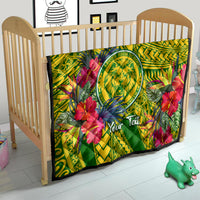 Green tropical quilt covering crib mattress with lion crest, hibiscus flowers, and Your Text
