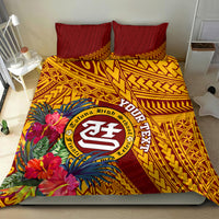 Maroon and gold bedding set with large circular crest, tropical flowers, and patterned comforter
