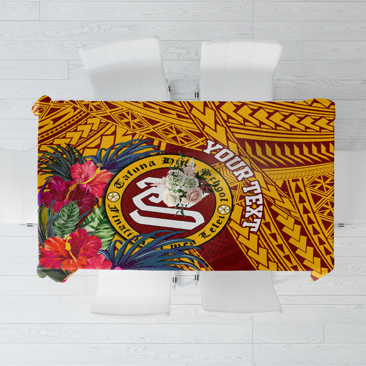 Maroon and gold tablecloth with tropical flowers and a central school crest