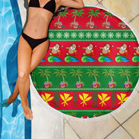 Round tropical Christmas beach blanket with red center, green sections, and white tassel fringe