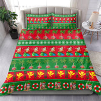 Christmas bedding set on bedspread with green/red Santa, palm trees, and presents; two pillowcases