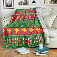Green Christmas throw blanket on a bed, showing Santa, candy cane circles, and bow patterns