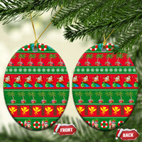 Ceramic oval Christmas ornament with red-and-green tropical holiday stripes and gold loop