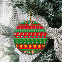 Ceramic circle Christmas ornament with red-and-green tropical stripes and gold hanging loop