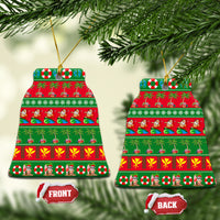 Ceramic bell-shaped Christmas ornament with red-and-green tropical print and gold hanging loop