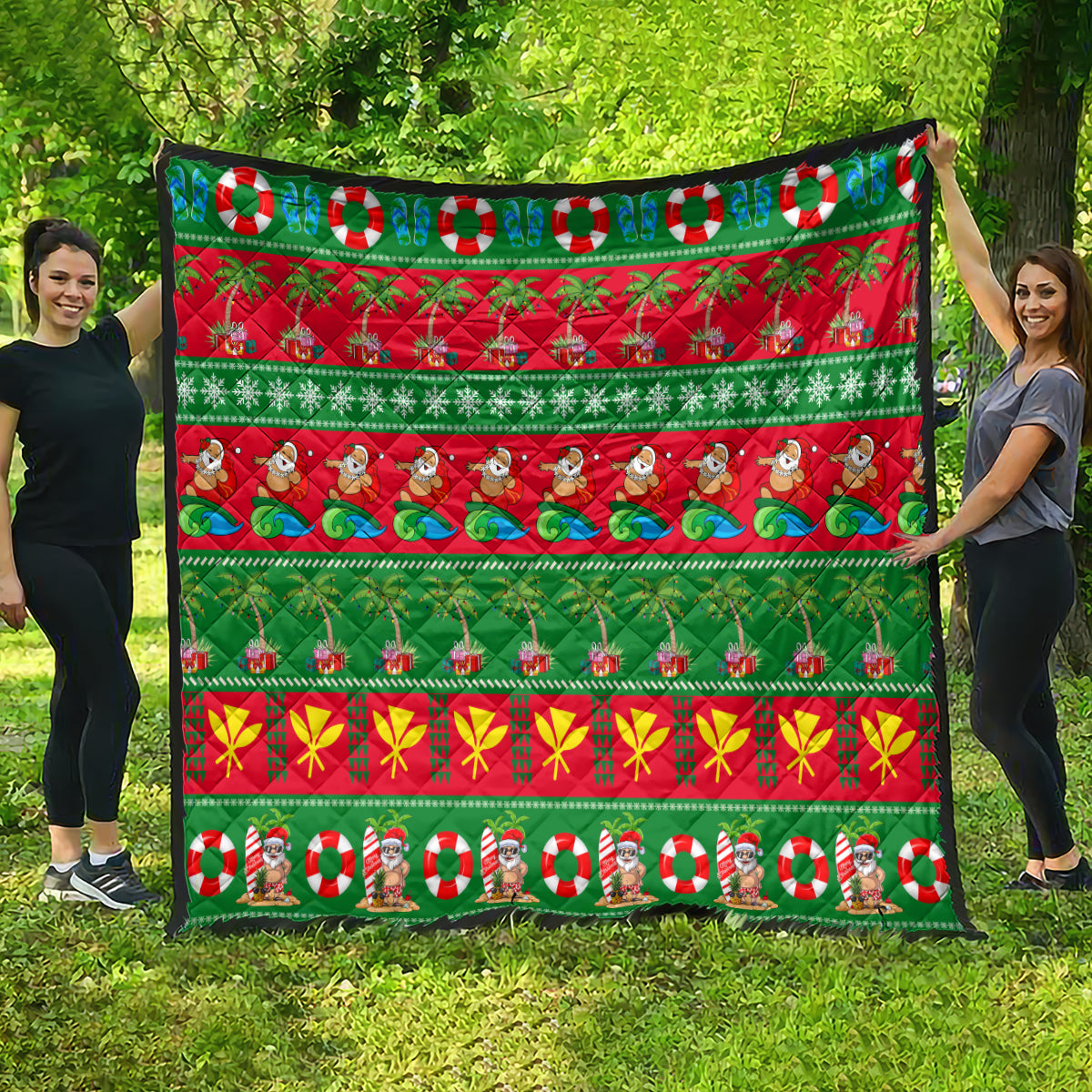 Hawaiian Christmas quilt spread out, green and red stripes with palm trees, candy canes, and Santa