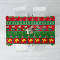 Green Christmas tablecloth with Santa and candy cane patterns, red trim