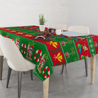 Green Christmas tablecloth on dining table with Santa and candy cane print
