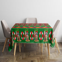 Green Christmas tablecloth on dining table with Santa, candy cane and star border