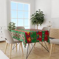 Green Christmas tablecloth on dining table with Santa and candy cane motifs
