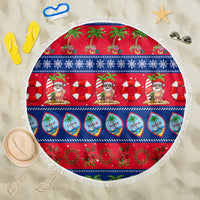 Round Christmas beach blanket with red-blue holiday pattern and fringed edge