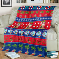 Christmas blanket on armchair with blue-and-red holiday pattern, palms and ornaments