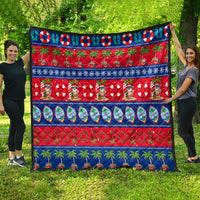 Colorful Christmas quilt featuring Santa, palm trees, ornaments, and striped blue trim