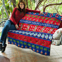 Christmas quilt on outdoor seating with red and blue stripes, Santa, and palm trees