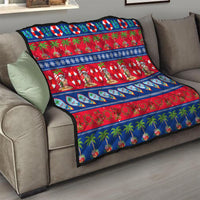 Christmas quilt draped on sofa with red field, blue trim, Santa and palm tree scenes