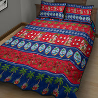 Christmas quilt bed set on bed: red and blue with palm trees, Santas, striped border