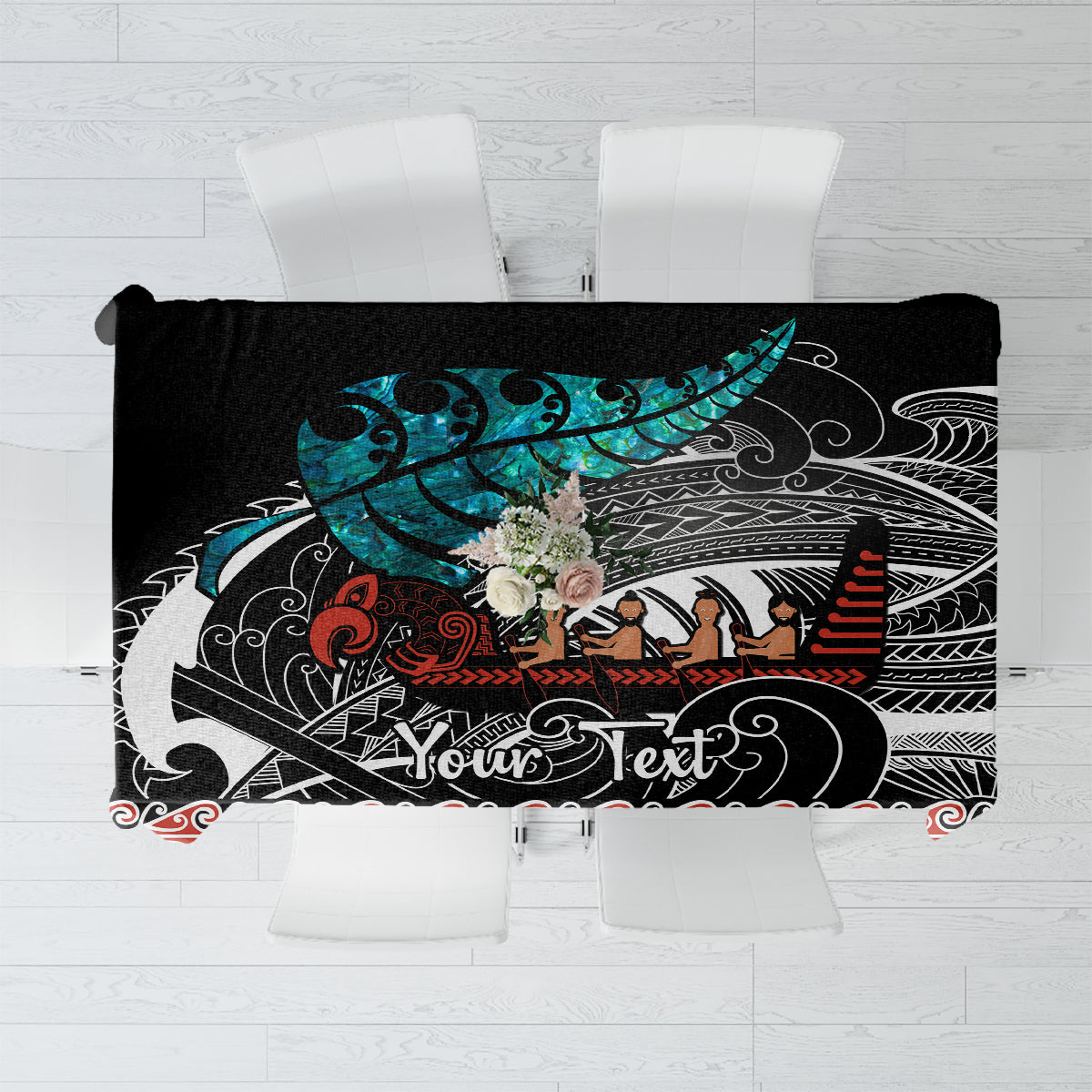 Black tablecloth with teal, red, and white Maori-style waka pattern