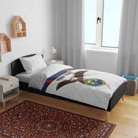 Navy and white football bedding set on bed frame with eagle emblem and crest logo.