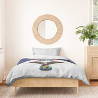 White football bedding set with eagle graphic and crest logo on a wooden bed frame.