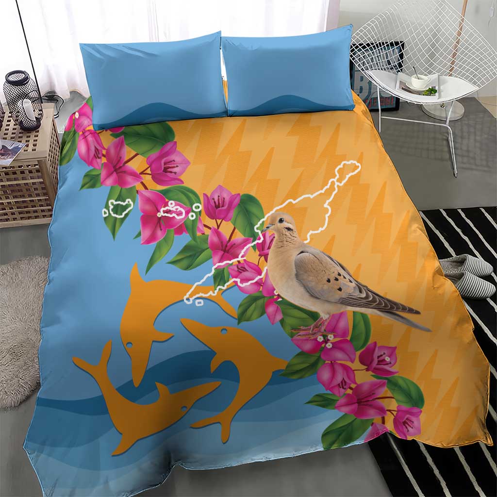 Duvet cover and two blue pillowcases featuring dove, dolphins, and tropical pink flowers